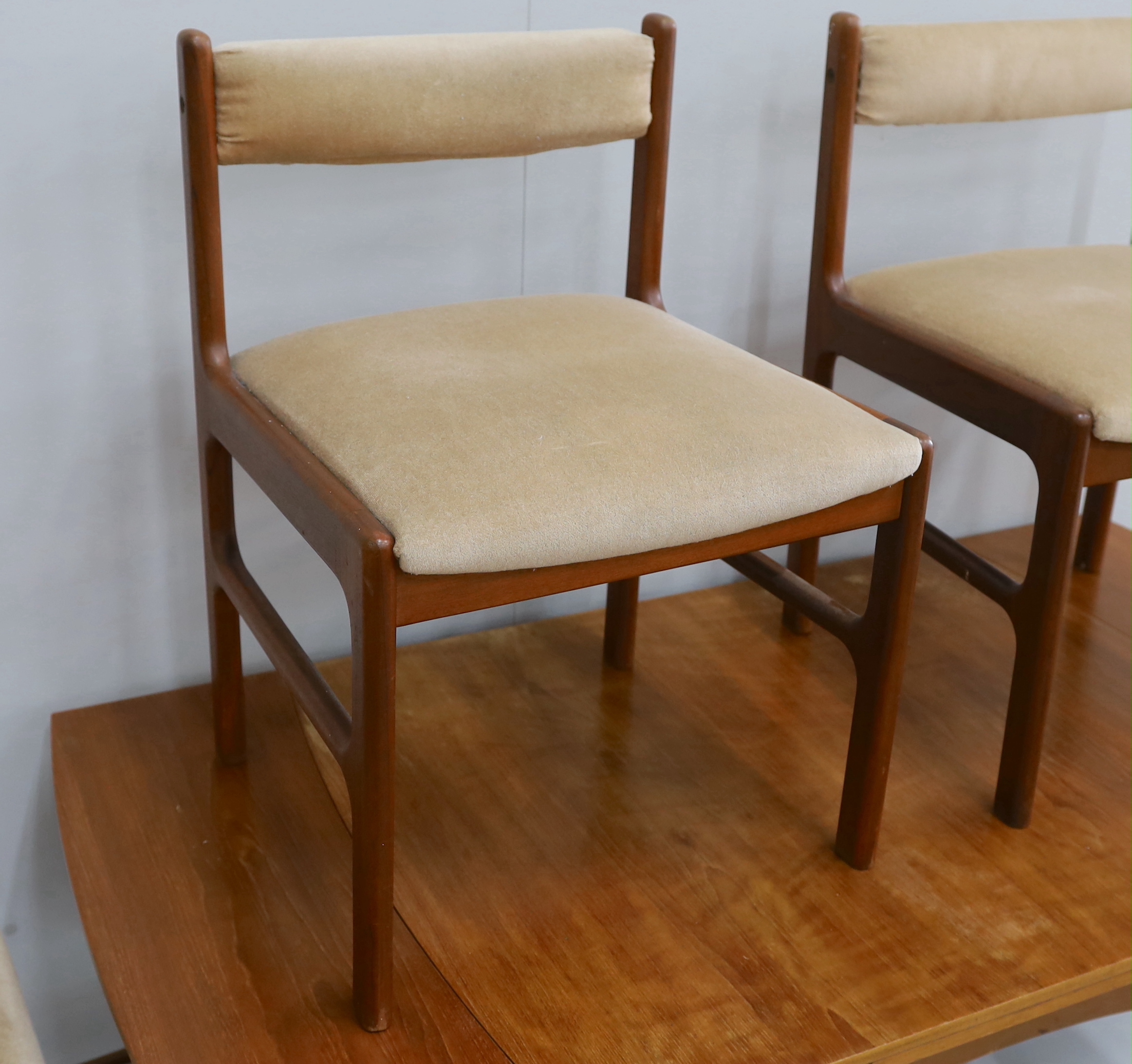 A mid century McInstosh teak draw leaf dining table, 150cm extended, depth 76cm, height 77cm and four chairs